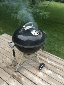 Lit Weber grill lid on vents open